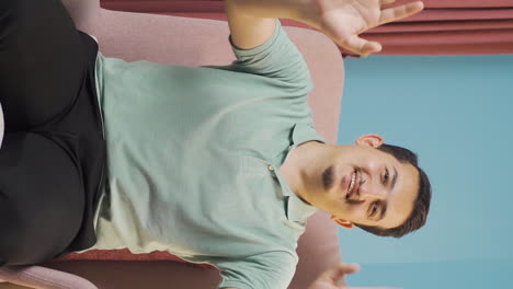 Vertical-video-of-The-man-waving-at-the-camera.